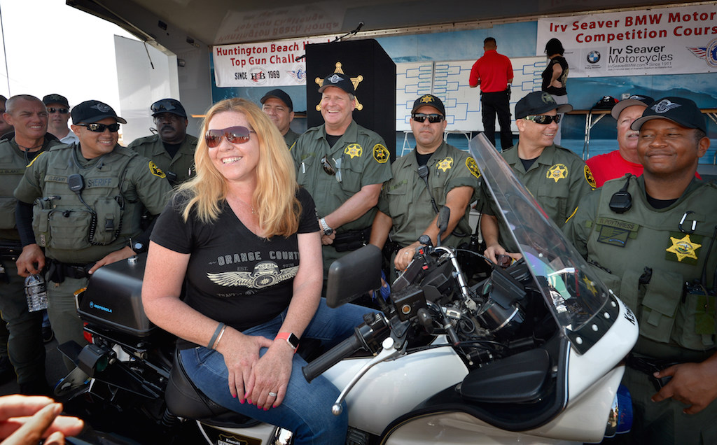 Orange County Sheriff Deputies draw a smile out of Geni Page, widow of husband Orange County Sherif Deputy Zach Page and long-time board member of the OCTOA, who passed away in July after a long battle with cancer, during an otherwise difficult day as a guest during the Orange County Traffic Officers Association’s annual Police Motorcycle Training and Skills Competition. Photo by Steven Georges/Behind the Badge OC
