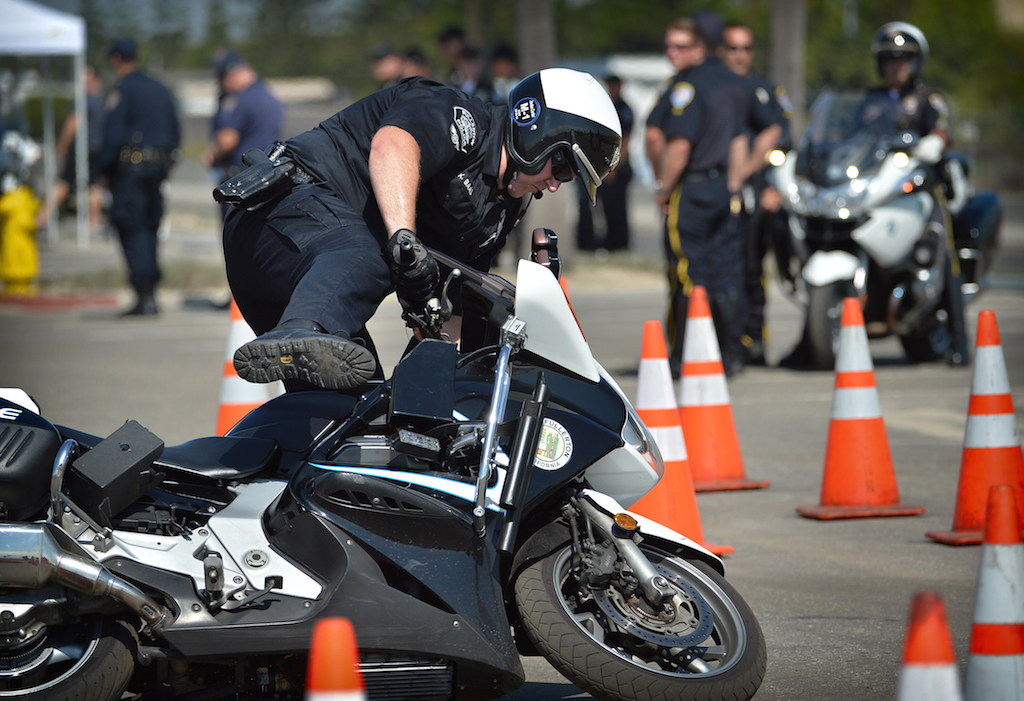 Tipping your motorcycle is common during the OCTOA competition when the tire hits the base of a traffic cone causing the wheel to slip, as Fullerton PD Officer Kyle Baas unwillingly demonstrates.  Photo by Steven Georges/Behind the Badge OC