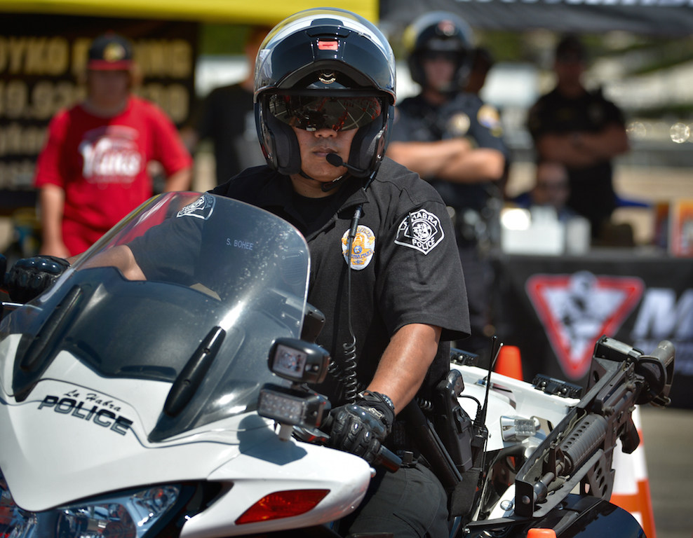 La Habra PD Motor Officer Sumner Bohee runs through the obstacle course during the finals for the Orange County Traffic Officers' Association’s annual Police Motorcycle Training and Skills Competition at Huntington State Beach. Photo by Steven Georges/Behind the Badge OC