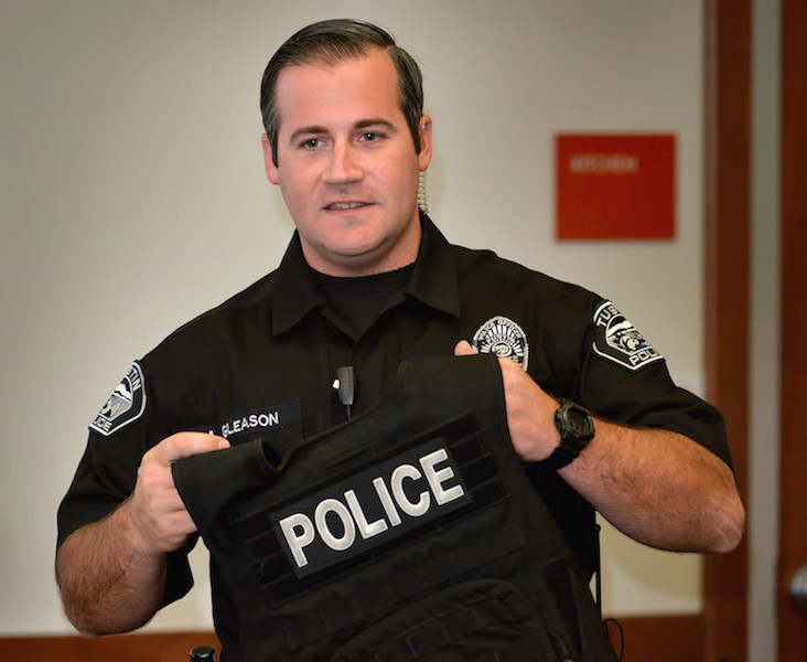 Tustin PD Officer Andrew Gleason holds up a bullet resistant vest as talks about the equipment officers use during a Use of Force seminar for citizens at the Tustin Civic Center. Photo by Steven Georges/Behind the Badge OC
