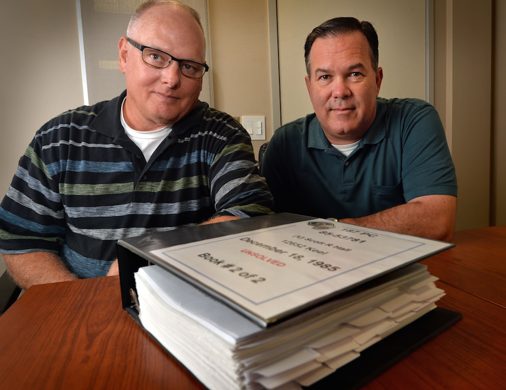 Garden Grove PD’s Sgt. Mike Martin, supervisor of the Crimes Against Persons Unit, left, and Inv. Mike Farley, Cold Case Homicide Unit, with the casebook of a cold case homicide that was just recently solved. Photo by Steven Georges/Behind the Badge OC