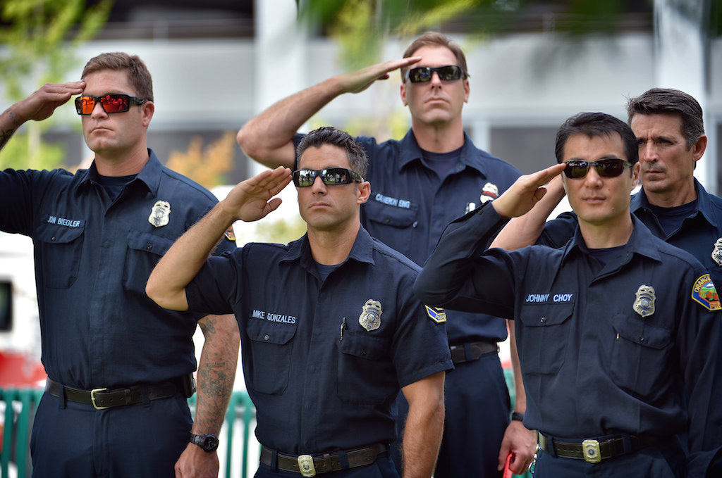 The Westminster fire department salutes the flag as the National Anthem is played during Westminster’s 9/11 Remembrance ceremony at the Sid Goldstein Freedom Park. Photo by Steven Georges/Behind the Badge OC