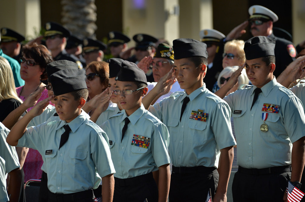 Cadets from St. Catherine's Academy in Anaheim salute as the colors are posted at the start of the 2015 9/11 Remembrance Ceremony at Anaheim Grand Plaza. Photo by Steven Georges/Behind the Badge OC