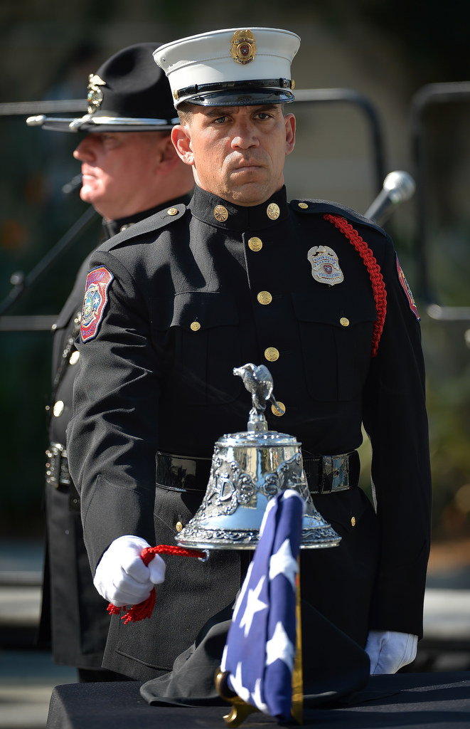 Anaheim Fire & Rescue Honor Guard Michel Bowidowicz rings the bell during the 9/11 Remembrance Ceremony at Anaheim Grand Plaza. Photo by Steven Georges/Behind the Badge OC Michel Bowidowicz (cq - misspelled on program)