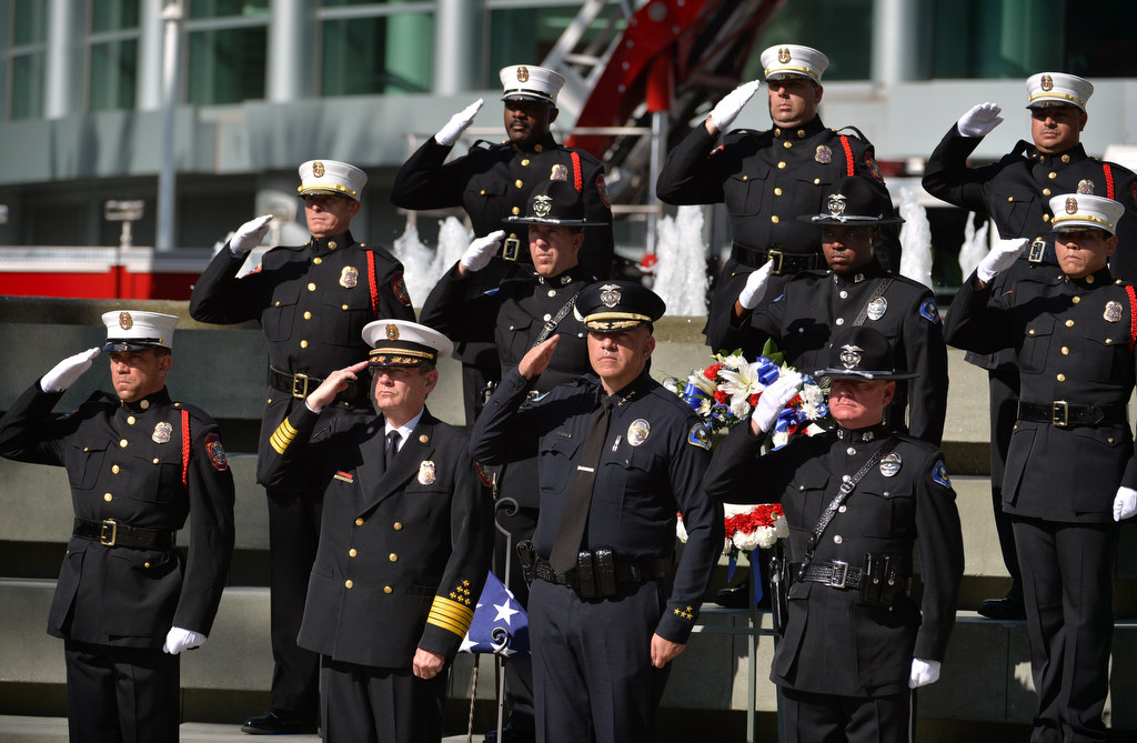 Anaheim Fire & Rescue Chief Randy Bruegman and Anaheim Police Chief Raul Quezada, front center, join the joint Honor Guard from Anaheim Fire & Rescue and Anaheim Police in a final salute during the conclusion of the 2015 9/11 Remembrance Ceremony at Anaheim Grand Plaza. Photo by Steven Georges/Behind the Badge OC