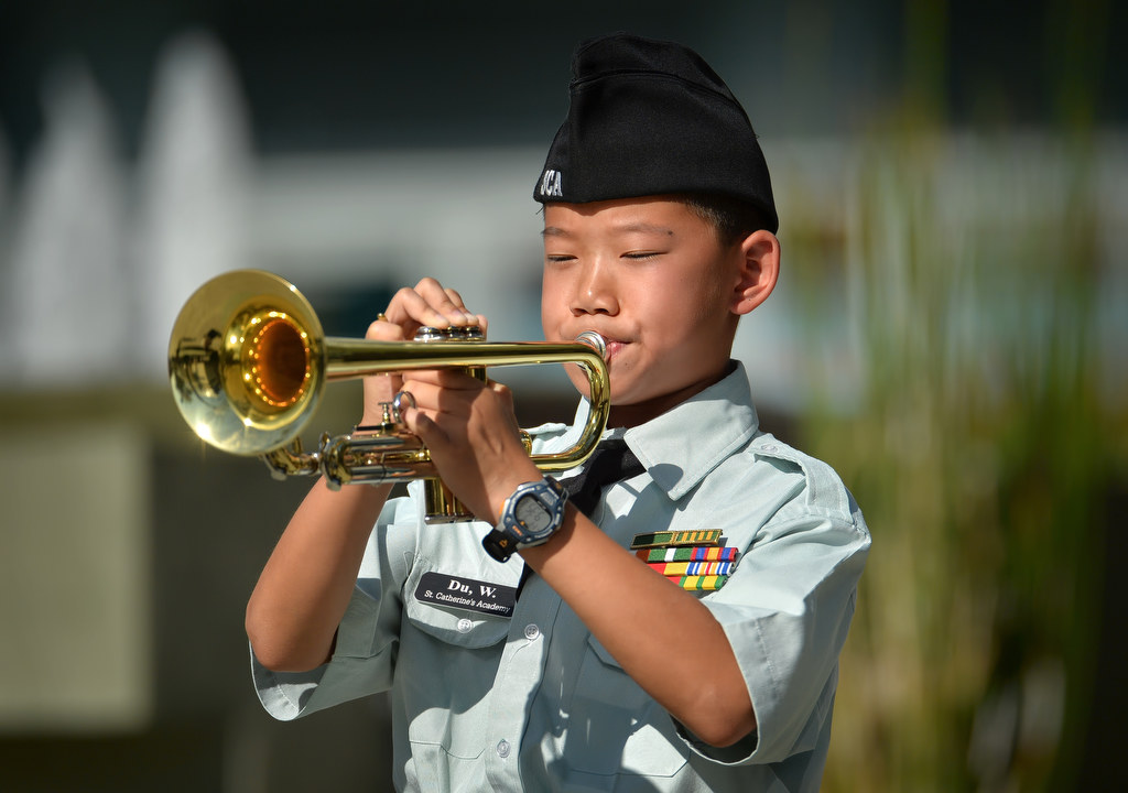 Bugler Weili Du from St. Catherine's Academy in Anaheim plays Taps at the conclusion of the 2015 9/11 Remembrance Ceremony at Anaheim Grand Plaza. Photo by Steven Georges/Behind the Badge OC