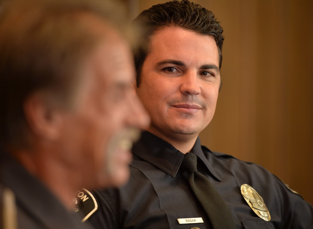 Fullerton PD Cpl. Kenny Edgar, right, looks over at Bill Easton of Fullerton as he tells his story about how Edgar helped him recover from a life of Meth. Photo by Steven Georges/Behind the Badge OC