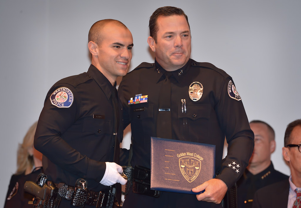 Westminster PD’s Alejandro Lopez receives his badge from Westminster Deputy Chief Dan Schoonmaker during the Golden West College Basic Police Academy, Class 150, graduation ceremony. Photo by Steven Georges/Behind the Badge OC
