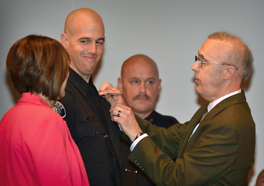 Cypress PD’s Christopher Bushman smiles as he gets his badge pinned to him by his family during the Golden West College Basic Police Academy, Class 150, graduation ceremony. Photo by Steven Georges/Behind the Badge OC