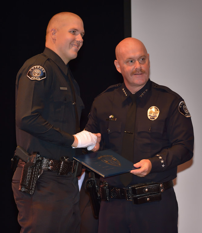 Cypress PD’s Kevin Lindsey receives his badge from Cypress Police Chief Rod Cox during the Golden West College Basic Police Academy, Class 150, graduation ceremony. Photo by Steven Georges/Behind the Badge OC