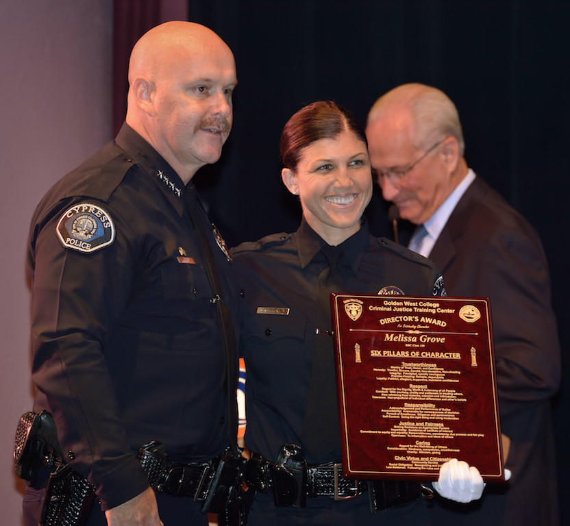 Cypress Police Chief Rod Cox stands with Cypress PD’s Melissa Grove as she receives the Director’s Award from the Golden West College Criminal Justice Training Center during a graduation ceremony at Orange Coast College. Photo by Steven Georges/Behind the Badge OC
