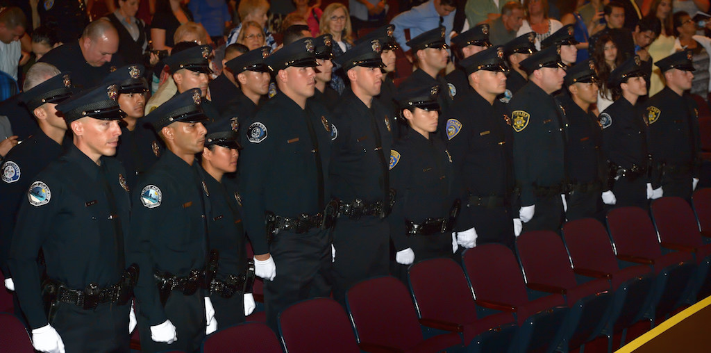 The graduating class from Golden West College Criminal Justice Training Center, Class 150, stand at the conclusion of a ceremony at Orange Coast College. Photo by Steven Georges/Behind the Badge OC