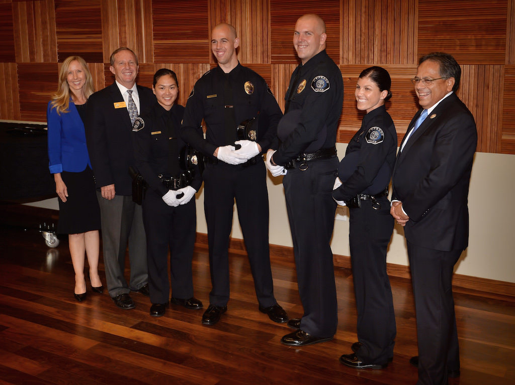 Claire Tran, Melissa Grove, Christopher Bushman and Kevin Lindsey with with Cypress Councilwoman Stacy Berry, left, Mayor Rob Johnson and councilman Paulo Morales, right, after they were sworn in by Cypress Police Chief Rod Cox during a small ceremony following the Golden West College Police Academy Class 150 graduation ceremony at Orange Coast College. Photo by Steven Georges/Behind the Badge OC