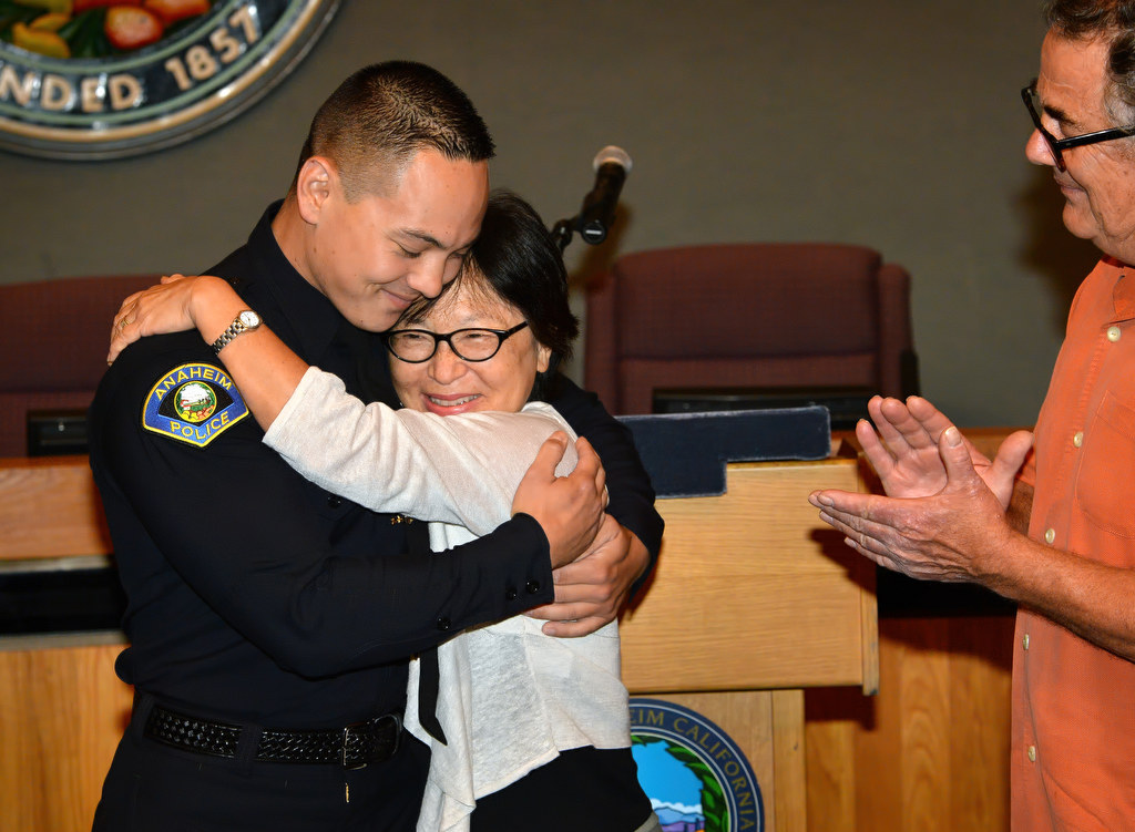 Bartman Horn, former Pasadena PD, gets a hug from his mother Amy after pinning his new Anaheim PD badge pinned to him during a swearing in ceremony at Anaheim City Hall. Photo by Steven Georges/Behind the Badge OC