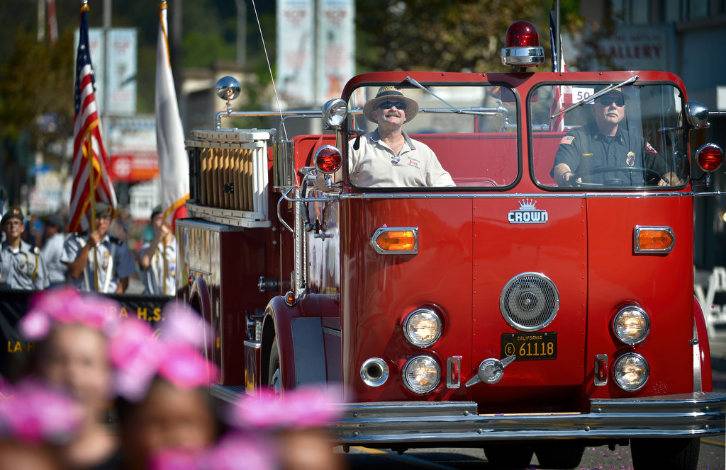 The Fullerton Fire Department takes a vintage fire engine down Harbor Blvd. for the Founders Day Parade. Photo by Steven Georges/Behind the Badge OC