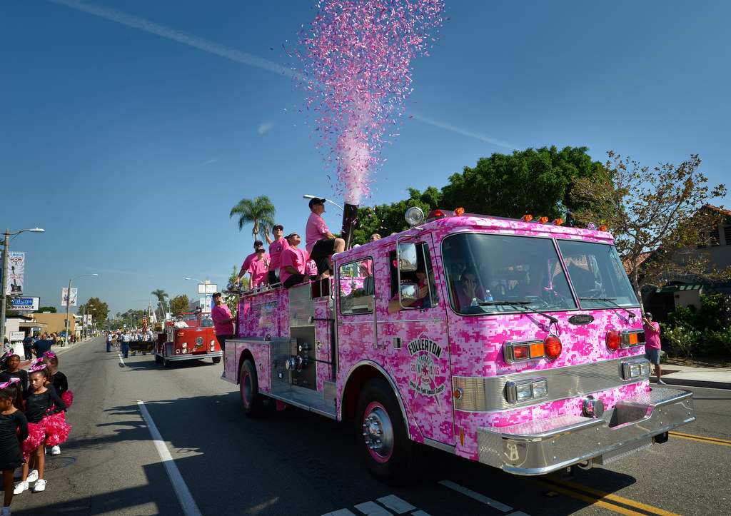 The Fullerton Fire Fighters Association shoot pink confetti in the air as they show their support for Cancer Awareness during the Founders Day Parade. Photo by Steven Georges/Behind the Badge OC