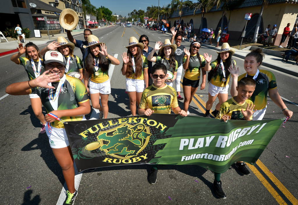 The Fullerton Rugby Team wave to people along the Founders Day Parade route in Fullerton. Photo by Steven Georges/Behind the Badge OC