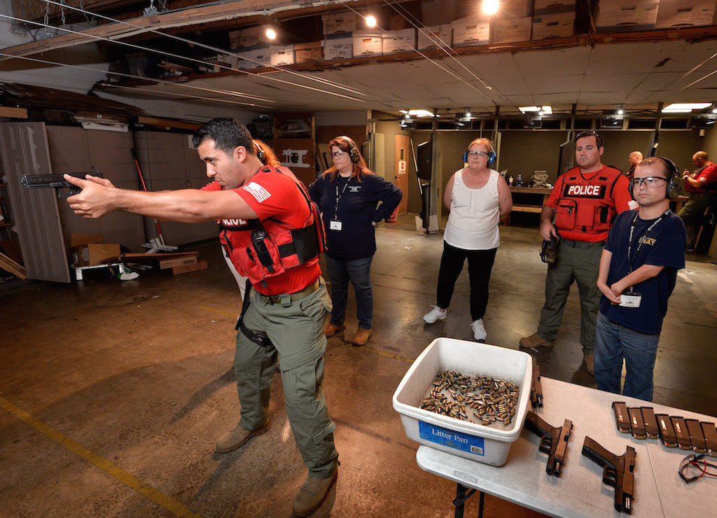 Officer Mike Carter of the Tustin PD demonstrates the proper technique for firing a weapon during Tustin PD’s Citizen's Academy class at Evans Shooters World Firing Range in Orange. Photo by Steven Georges/Behind the Badge OC
