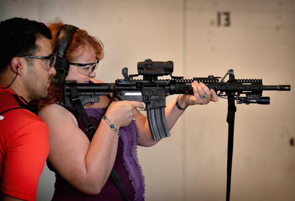 Stella Kotova of Tustin fires an AR-15 under the watchful eye of Tustin PD Officer Mike Carter during a citizen's academy class. Photo by Steven Georges/Behind the Badge OC