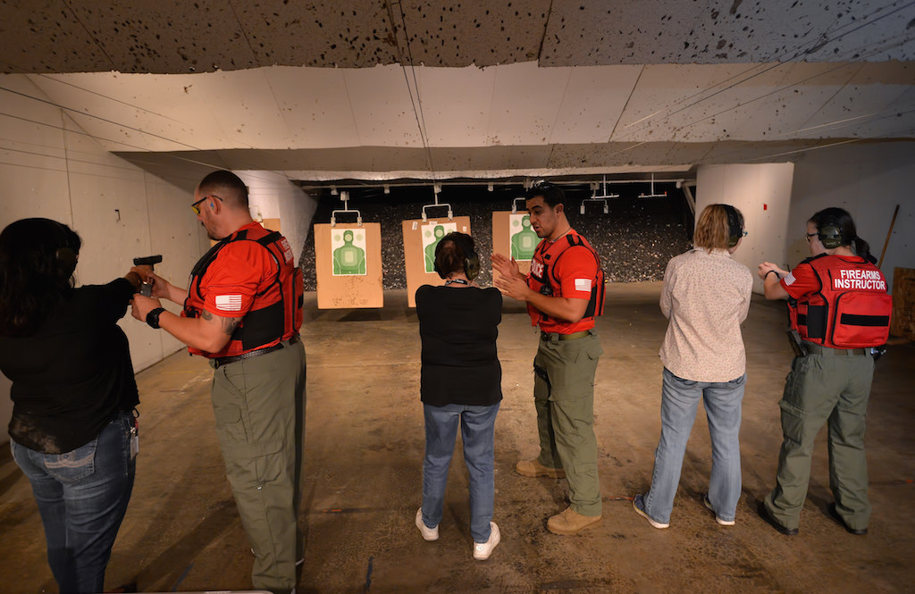 Tustin police officers teach how to handle and fire a gun during a Tustin PD Citizen's Academy class at Evans Shooters World Firing Range in Orange. Photo by Steven Georges/Behind the Badge OC