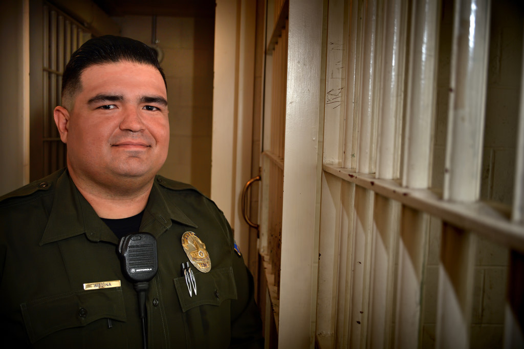 Carlos Medina, a Jailer at the Fullerton PD city jail, talks about his experiences at the jail. Photo by Steven Georges/Behind the Badge OC
