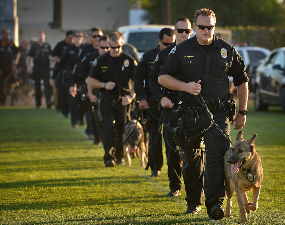 Anaheim PD Officer Brett Klevos leads the K-9 officers entering the stadium with his dog Guenther at the start of the OCPCA’s 27th Annual Police K-9 Benefit Show at Glover Stadium in Anaheim. Photo by Steven Georges/Behind the Badge OC