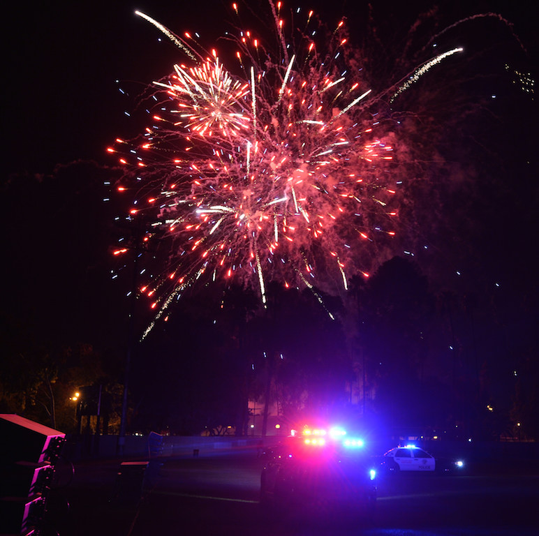 Fireworks go off overhead as K-9 patrol cars use their code-3 lights to light up Glover Stadium during the OCPCA’s 27th Annual Police K-9 Benefit Show in Anaheim.  Photo by Steven Georges/Behind the Badge OC