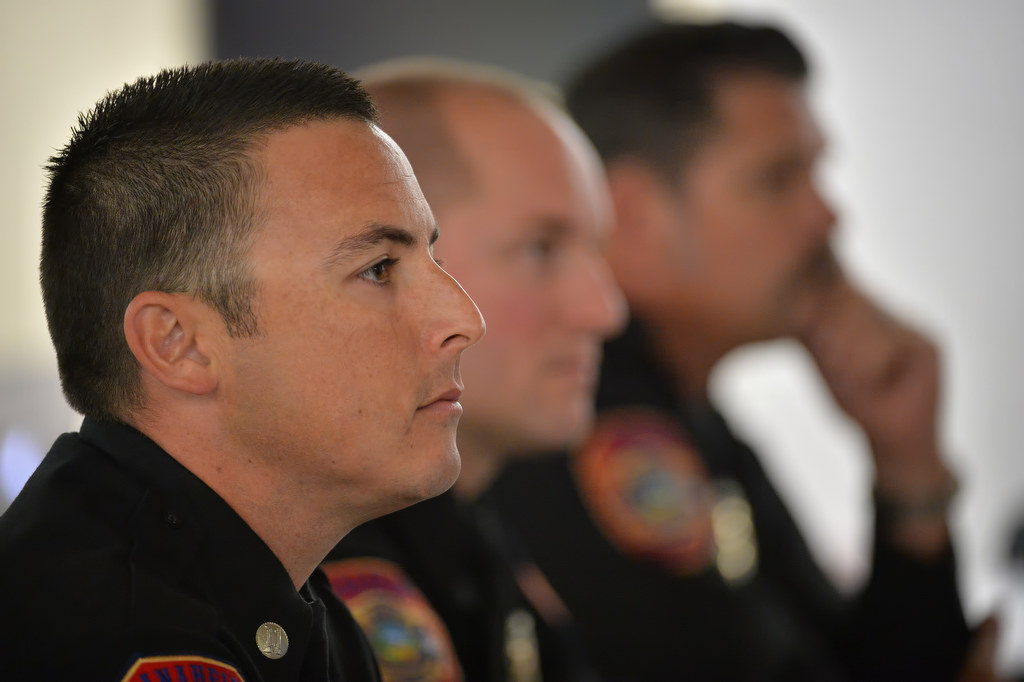 Captain Nicholas Colonelli of Anaheim Fire & Rescue, left, listens to the chiefÕs speech during AnaheimÕs Fire Leadership Academy graduation ceremony. Next to him is Todd Needle and Matthew Zaun. Photo by Steven Georges/Behind the Badge OC