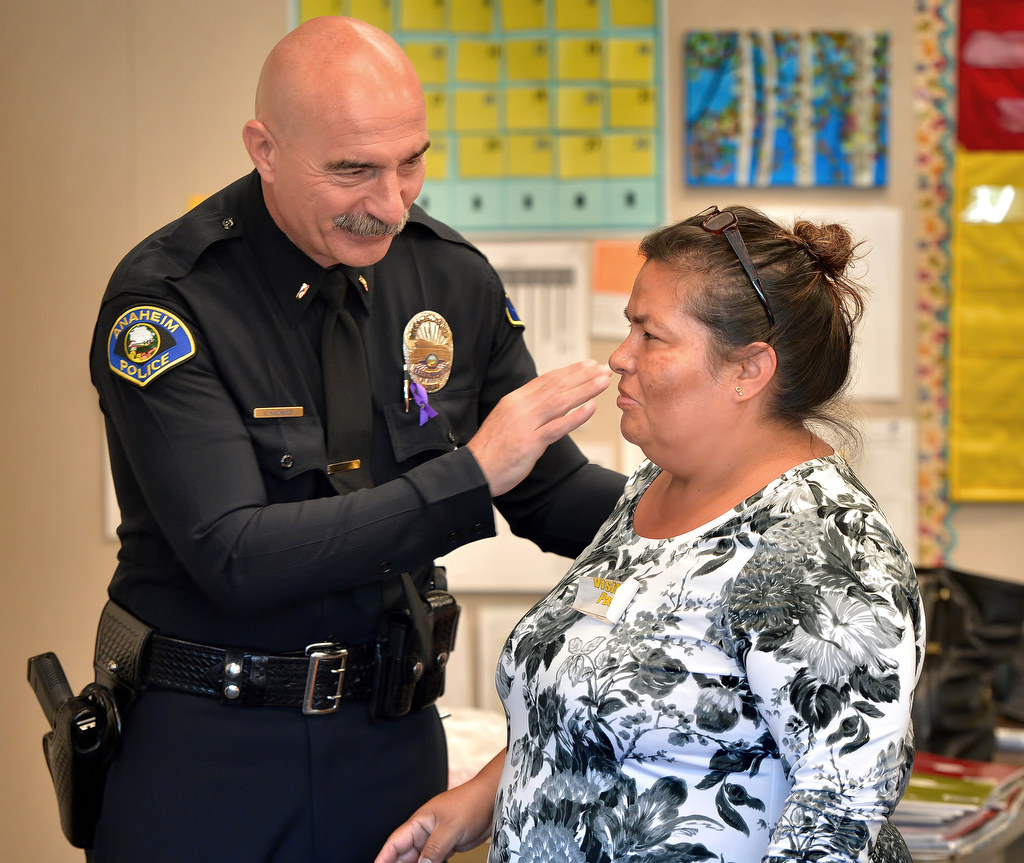 Anaheim PD Lt. James Kazakos congratulates Maria Isabel Palafox for completing a program from the Orange County Family Justice Center Foundation. Photo by Steven Georges/Behind the Badge OC