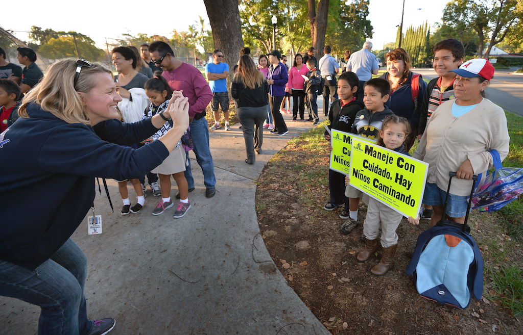 Estock Elementary School Principal Beth Blackman captures the morning event with her camera as kids arrive at Pepper Tree Park for Tustin PD’s annual Walk to School campaign. Photo by Steven Georges/Behind the Badge OC