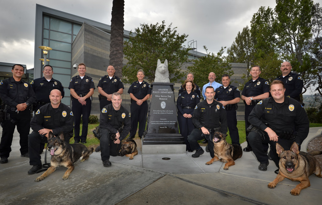 Anaheim PD’s K-9 support staff with the k-9 handlers Brian Bonczkiewicz with his dog xxx, left, RY Young with his dog Yukon, Matt Sutter with his dog Jager, and Brett Klevos with his dog Guenther, during during Anaheim PD’s K-9 memorial dedication at the PD’s East Sub Station. Photo by Steven Georges/Behind the Badge OC