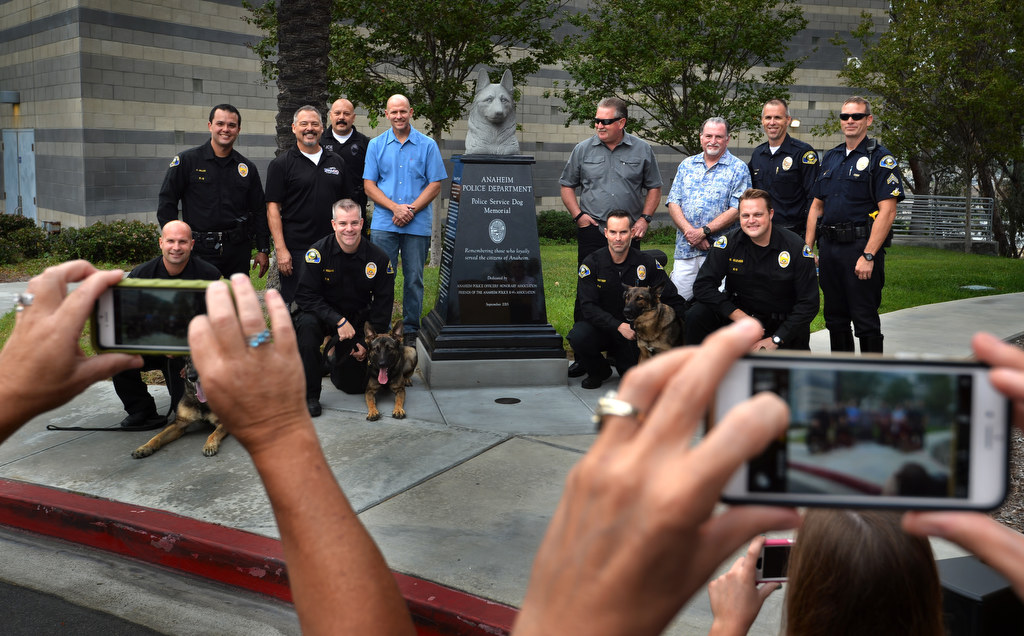 Anaheim current, former and retired K-9 officers stand for photos during Anaheim PD’s K-9 memorial dedication at the PD’s East Sub Station. Photo by Steven Georges/Behind the Badge OC