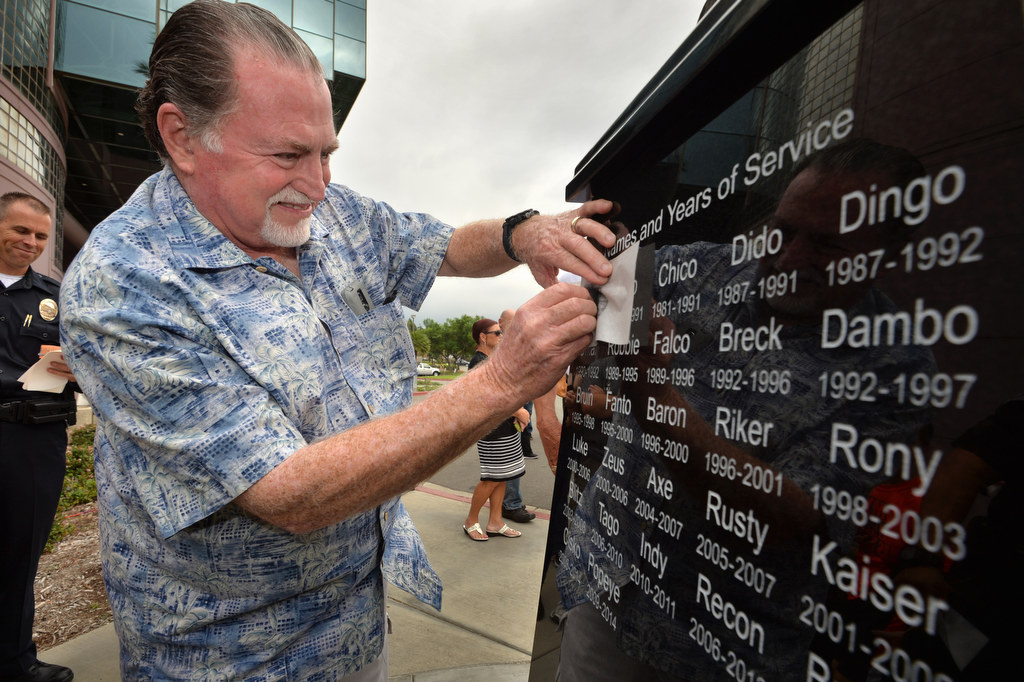 xxx sketches the name “Cliff” from the Anaheim Police Service Dog Memorial after a dedication ceremony at the Anaheim PD East Sub Station. Photo by Steven Georges/Behind the Badge OC