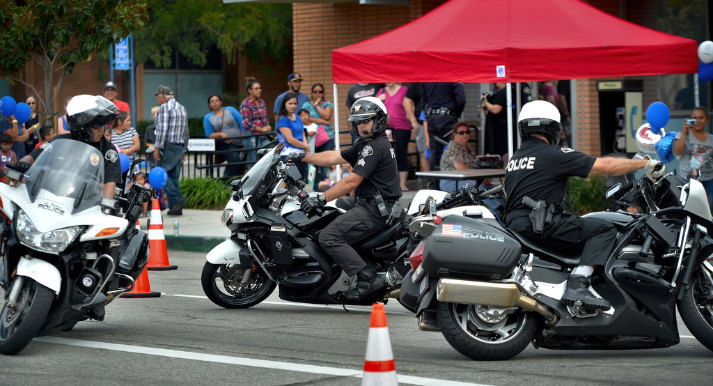 Officer Sumner Bohee, left, Sgt. Jim Tigner and Officer James Geer of the La Habra PD show their motorcycle skills to the crowd during La Habra PD’s open house. Photo by Steven Georges/Behind the Badge OC