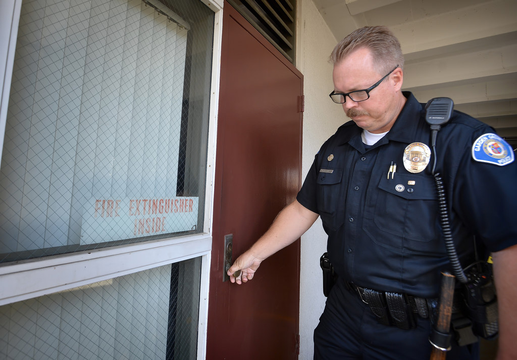 Officer Gary Elkins, of the Garden Grove PD Youth Services Unit, walks through Garden Grove High during a lockdown drill checking doors and looking to see if there is any lights or activity inside the classroom. Photo by Steven Georges/Behind the Badge OC