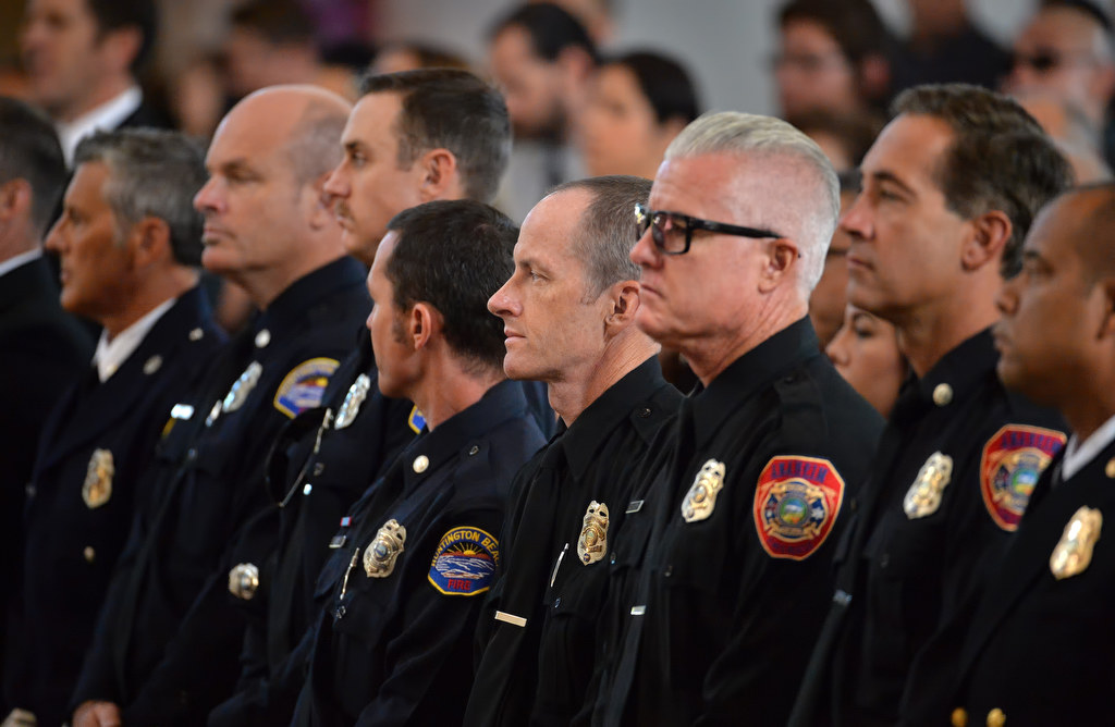 Firefighters from various fire departments, including Anaheim and Huntington Beach, attend the memorial service for Metro Net Dispatcher John Delgado inside the La Purisima Catholic Church in Orange. Photo by Steven Georges/Behind the Badge OC
