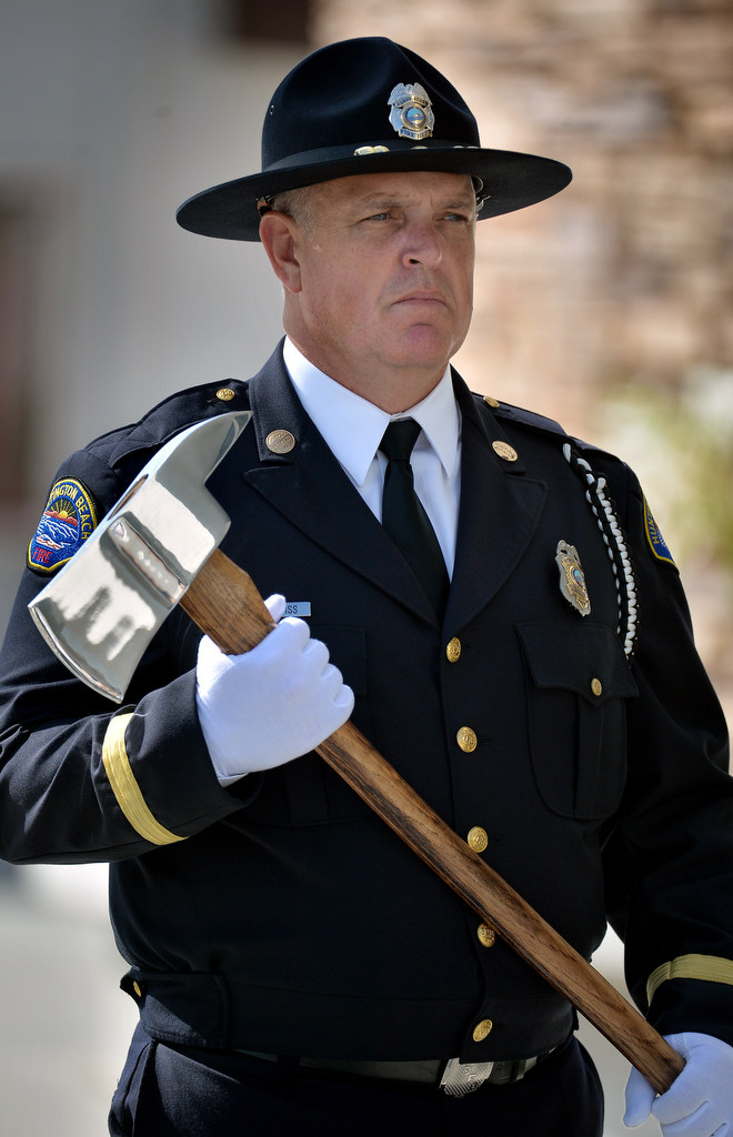 Kevin Prentiss, part of the Huntington Beach Fire Department's Honor Guard, stands at attention at the start of funeral services for Metro Net Dispatcher John Delgado at La Purisima Catholic Church in Orange. Photo by Steven Georges/Behind the Badge OC