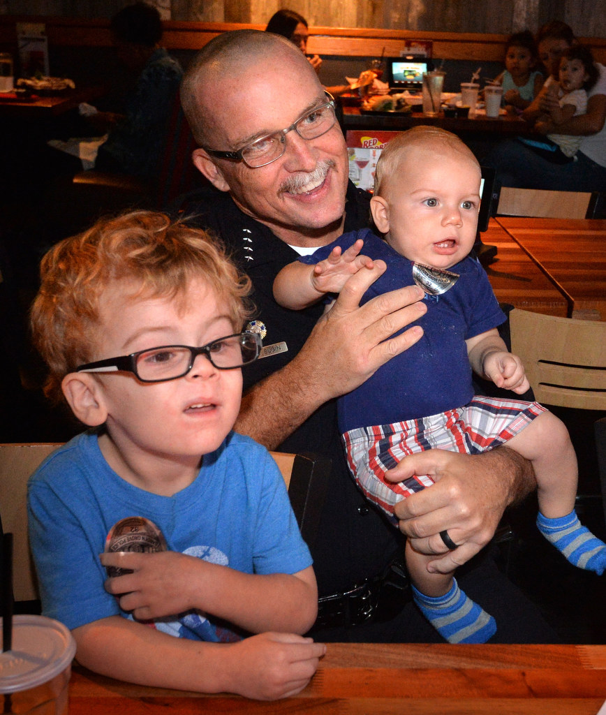 Garden Grove Police Chief Todd Elgin with Dax Duesler, 3, of Garden Grove, left, and his brother, 9-month old Clifford Duesler, during the Tip a Cop fundraiser for Special Olympics. Photo by Steven Georges/Behind the Badge OC