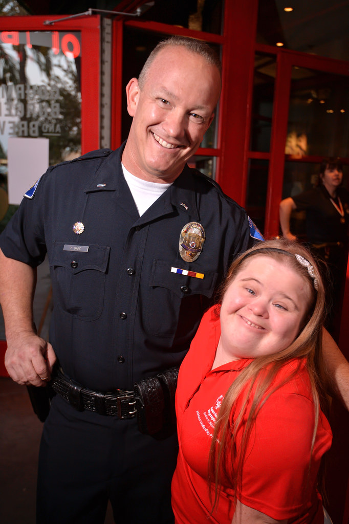 Garden Grove PD Lt. Thomas DaRé smiles with Special Olympics athlete Shannon Dieriex during the Tip a Cop fundraiser for Special Olympics at Red Robin Restaurant in Garden Grove. Photo by Steven Georges/Behind the Badge OC