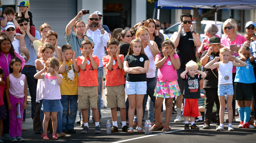 Kids, and their parents, cover their ears waiting for a flash bang grenade to be used during a SWAT demonstration, part of Fullerton PD’s Fourth Annual Police Department Open House. Photo by Steven Georges/Behind the Badge OC