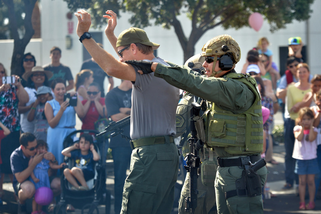 A simulated “bad guy” is taken into custody by Fullerton PD during a SWAT demonstration, part of Fullerton PD’s Fourth Annual Police Department Open House. Photo by Steven Georges/Behind the Badge OC