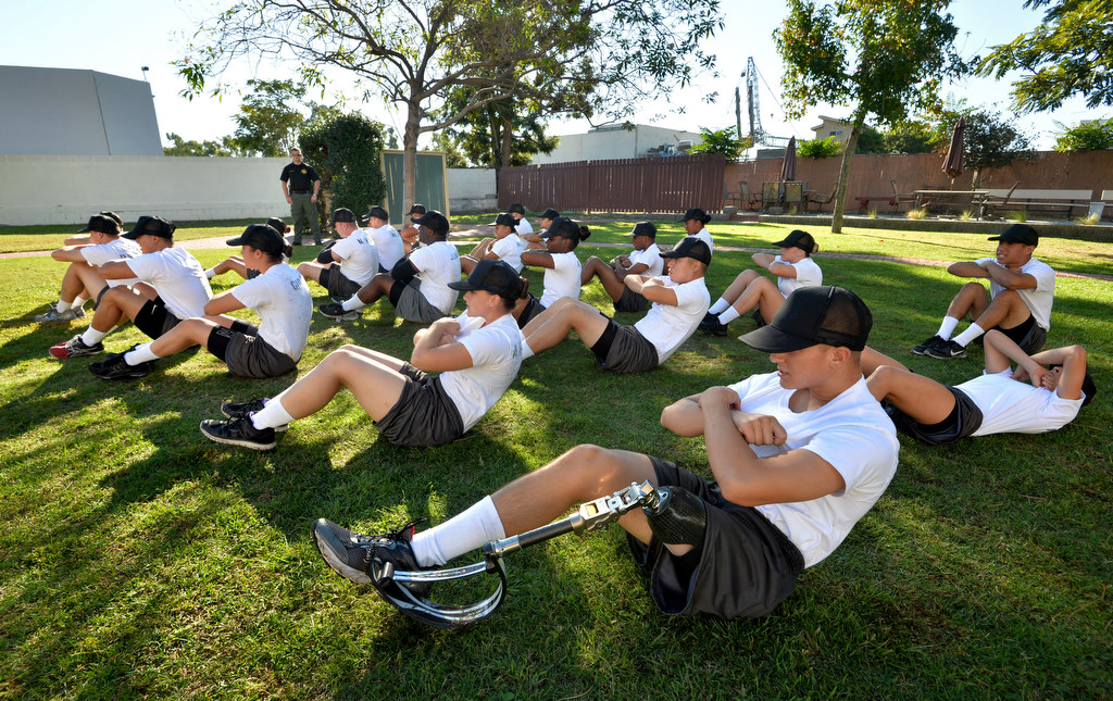 Correctional Services Assistant Recruit Robert Ram, who lost his left leg at age 12 due to cancer, performs sit-ups with his classmates at the Orange County Sheriff’s Department Correctional Services Assistant (CSA) Academy. Photo by Steven Georges/Behind the Badge OC