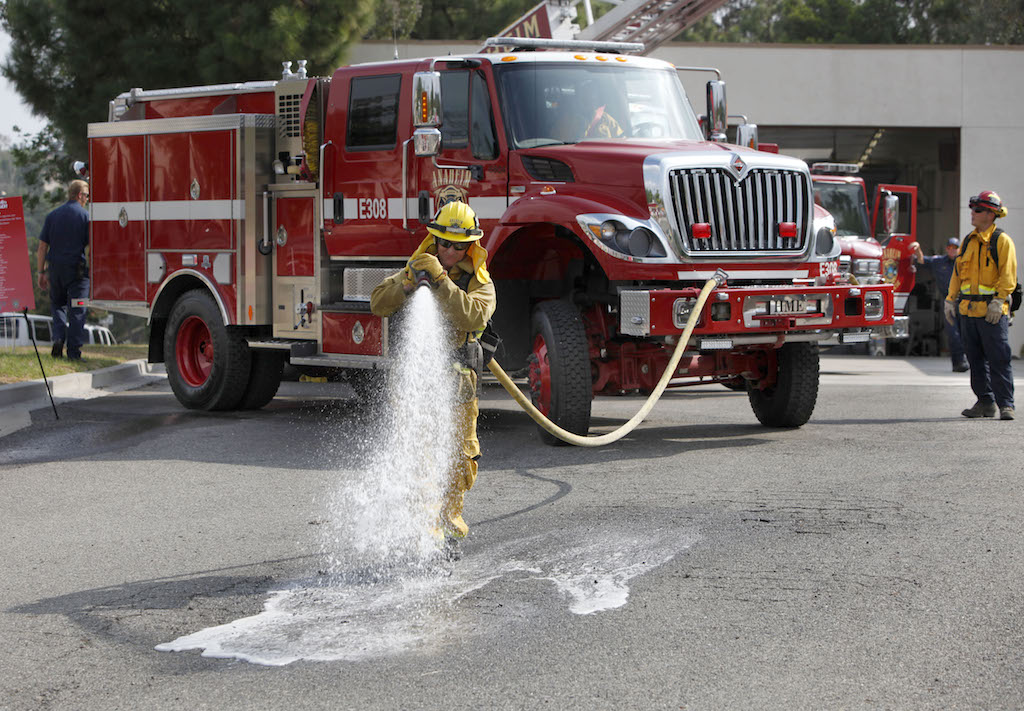 Fire fighters participate in a progressive hose laying demonstration during the Ready, Set Go Block Party Anaheim Fire Department Station No.10. Photo by Christine Cotter/Behind the Badge OC