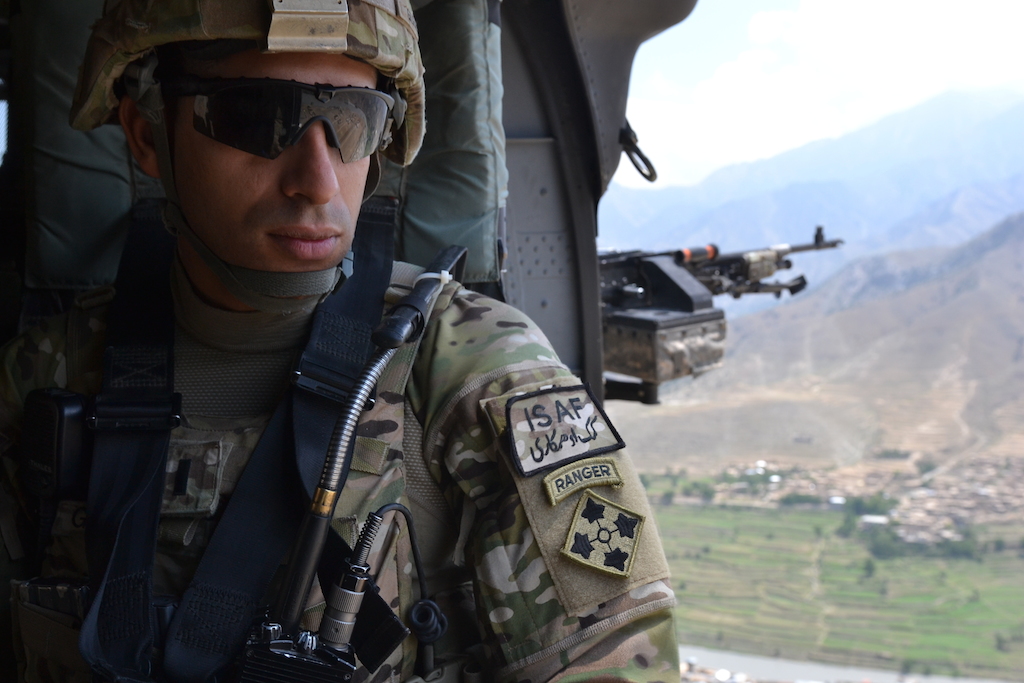 U.S. Army 1st. Lt. Florent A. Groberg, officer in charge for personal security detail, 4th Brigade Combat Team, 4th Infantry Division, enjoys the view from a UH-60 Black Hawk helicopter traveling over the Kunar province July 16, 2012. Photo courtesy of U.S. Army