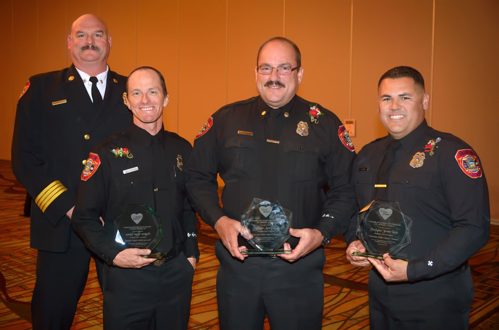 Anaheim Fire & Rescue Deputy Chief Pat Russell, left, with three recipients of the Heroes with Heart award that includes, from left, Engineer Roger Domen, Captain Andy Ball and Firefighter Jeremy Keith. Firefighter Denny Munson was not present. Photo by Steven Georges/Behind the Badge OC
