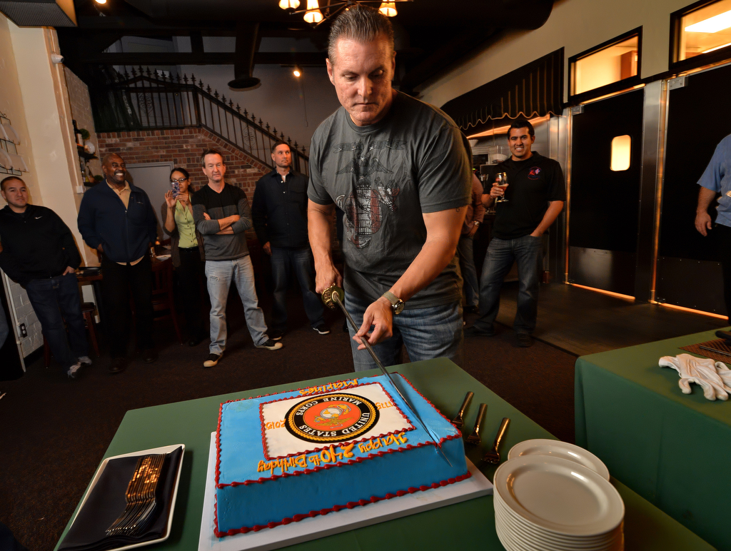 Tustin PD Sgt. Del Pickney, who also served in the Marines, cuts the cake with a Marine Corps sword during a gathering to honor the Marine Corps 240th birthday by current and retired Tustin police officers. Photo by Steven Georges/Behind the Badge OC