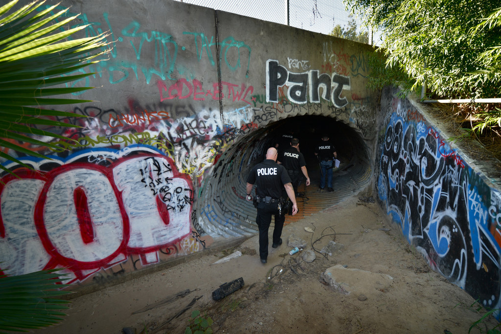 Officers from Fullerton PD and La Habra PD enter flood control tunnels near Harbor Blvd. and Imperial Hwy. looking for homeless people that might be living there, which would be dangerous should it rain. Photo by Steven Georges/Behind the Badge OC