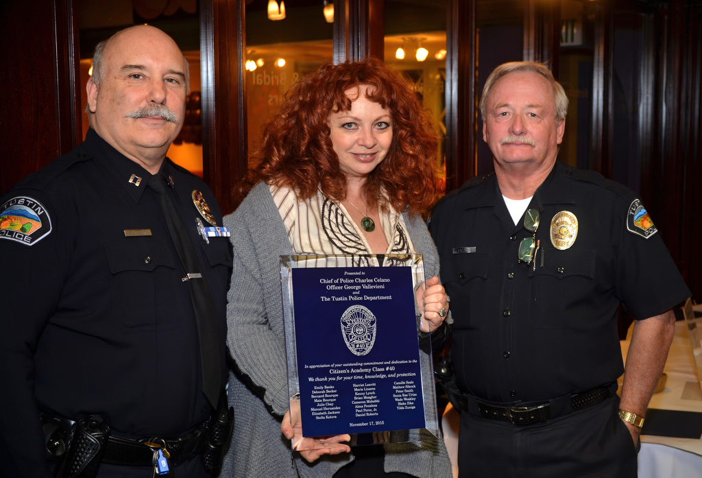 Stella Kotova presents the Citizen Academy Class No. 40 plaque with all the students names on it to Tustin Police Capt. Steve Lewis, left, and Officer George Vallevieni during a graduation ceremony. Photo by Steven Georges/Behind the Badge OC