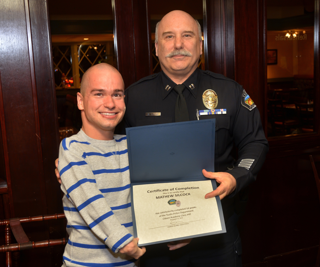Mathew Silcock receives his Citizen Academy Class #40 certificate from Tustin Police Captain Steven Lewis during a graduation ceremony. Photo by Steven Georges/Behind the Badge OC