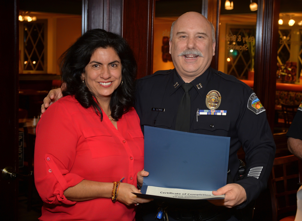 Yilda Zuniga receives her Citizen Academy Class No. 40 certificate from Tustin Police Capt. Steve Lewis during a graduation ceremony. Photo by Steven Georges/Behind the Badge OC